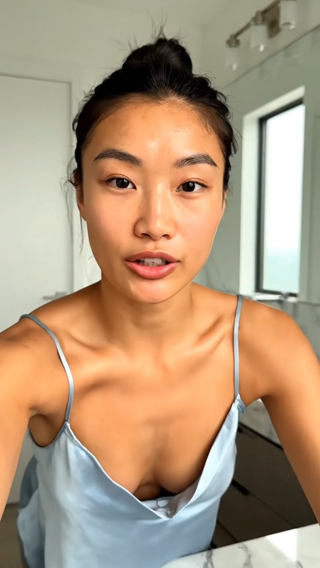 Vertical 9:16, 8 seconds, ultra-realistic UGC selfie talk-to-camera, handheld phone camera, natural indoor daylight by a window, modern bathroom/vanity background, slight camera shake, soft beauty lighting, high realism, natural audio implied.

Creator:
stylish young woman (early 20s), friendly and confident, natural makeup, healthy glowing skin, clear lip movement, expressive eyes, subtle hand gestures. No explicit content. No brand logos.

IMPORTANT:
NO subtitles, NO on-screen text, NO captions, NO watermarks.

“BEFORE/AFTER FEEL” WITHOUT EXAGGERATION:
Use subtle lighting/angle change + quick jump cut to create a believable difference:
- “Before” = slightly flatter lighting, neutral expression, a bit tired look (still natural).
- “After” = slightly warmer brighter window light, same person, fresher glow, relaxed smile.
No unrealistic smoothing, no face shape changes.

SHOT PLAN + SCRIPT (English voice):
0.0–1.8s (HOOK, BEFORE look):
Creator leans in, honest tone:
“I wish I knew this earlier—my makeup used to look tired by noon.”

1.8–3.2s (SETUP):
Creator shows a sleek, generic, unbranded skincare/makeup product close to the camera (no readable label), then lowers it:
“So now I do this for 30 seconds before makeup.”

3.2–6.2s (AFTER look + BENEFITS):
Jump cut to slightly warmer light, fresher glow:
“It makes my skin look instantly healthier, and my base goes on so much smoother.”

6.2–8.0s (CTA + SLOGAN):
Creator smiles, points down:
“Youth never expires. Tap to try it.”

Visual notes:
realistic skin texture, soft natural glow, warm-neutral grade, believable UGC framing, no text overlays, no logos.